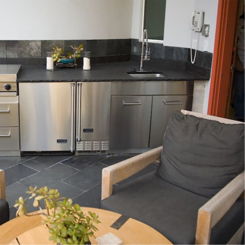 Stainless steel sink base cabinet with two doors, drawers, and faucet