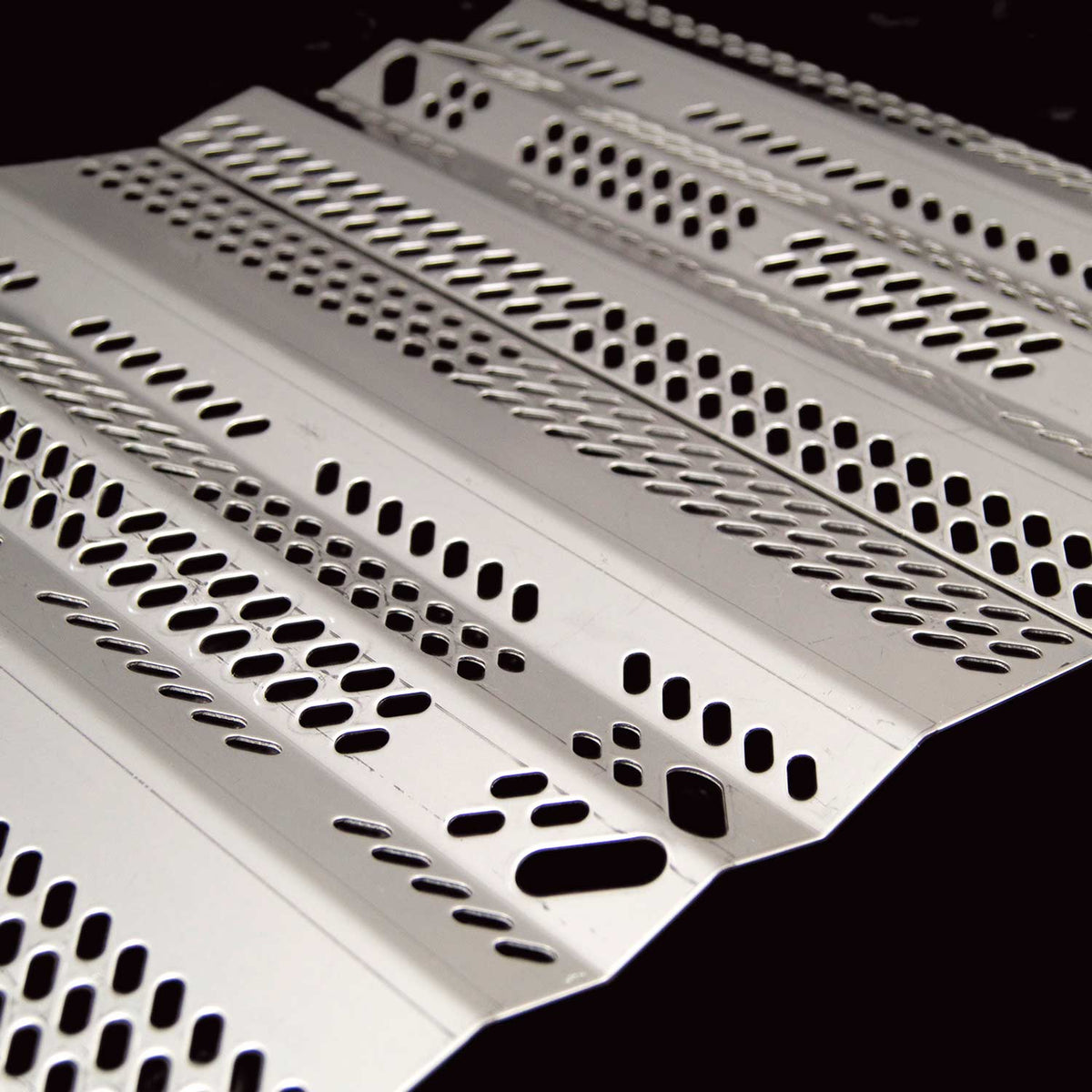 Stainless grill burner cover with rows of perforations