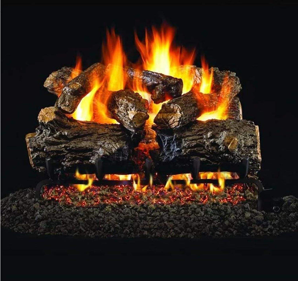 Vented gas log set with burnt rustic oak logs and glowing flames in a fireplace
