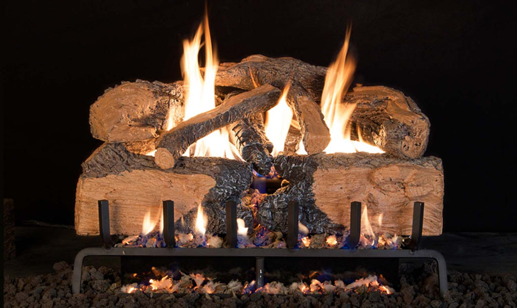 Charred split oak vented gas log set with glowing flames and embers