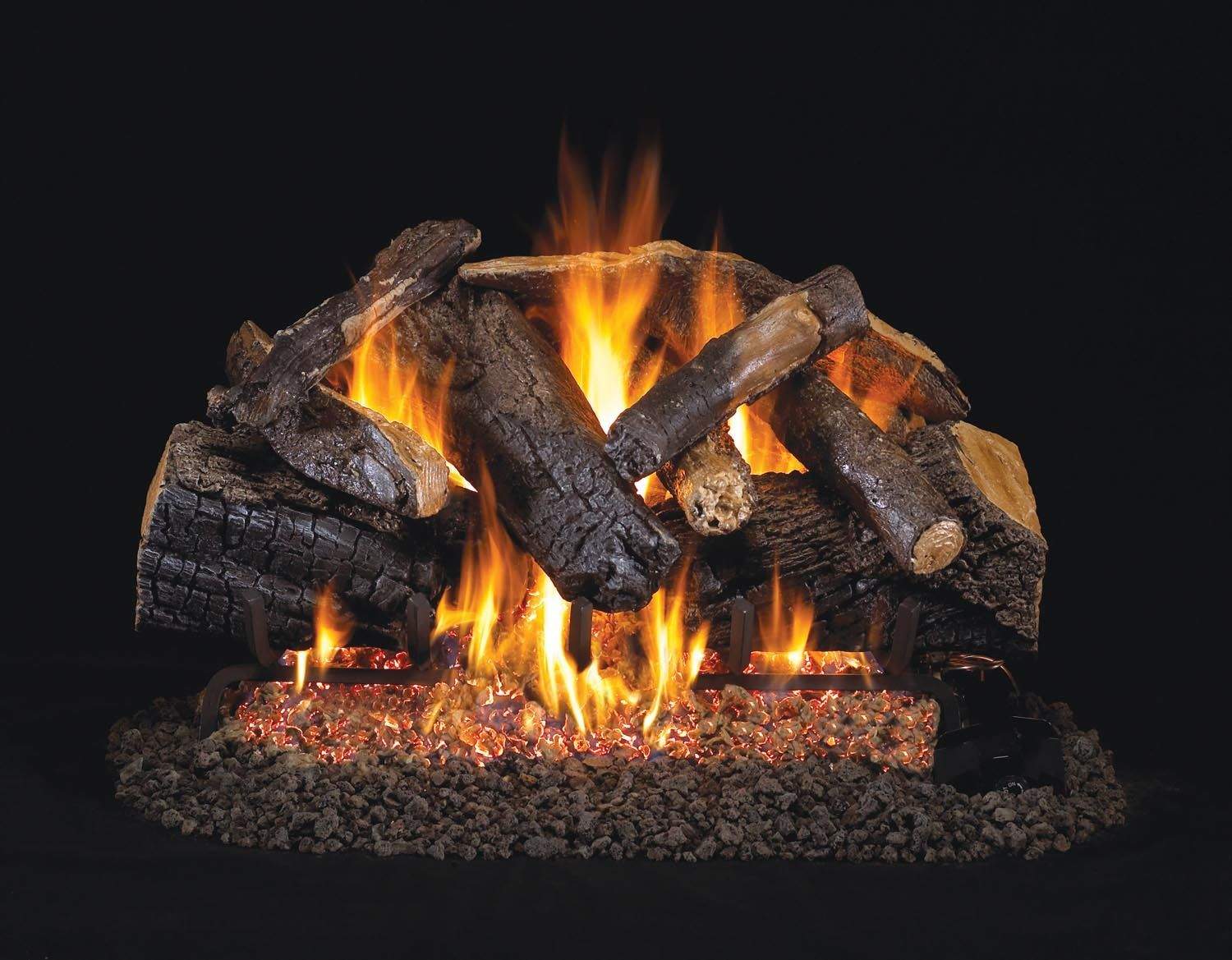 Vented gas log set with charred oak logs burning with flames and glowing embers