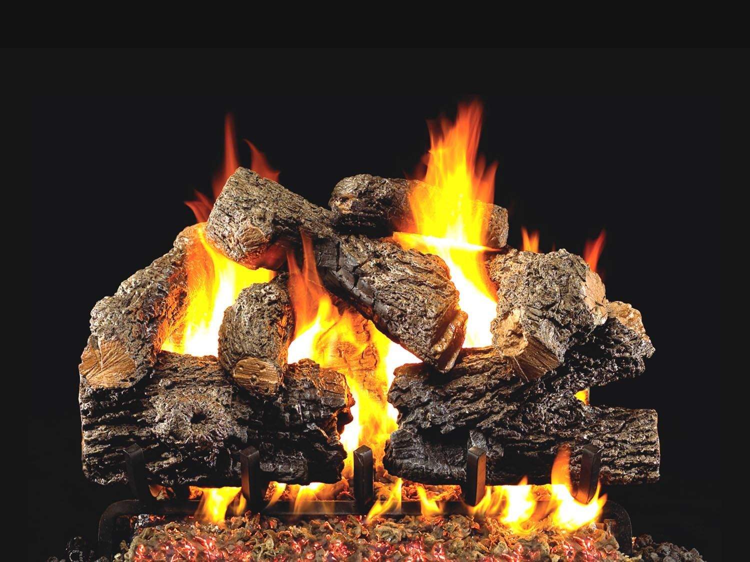 Vented gas log set with charred oak logs and bright flames