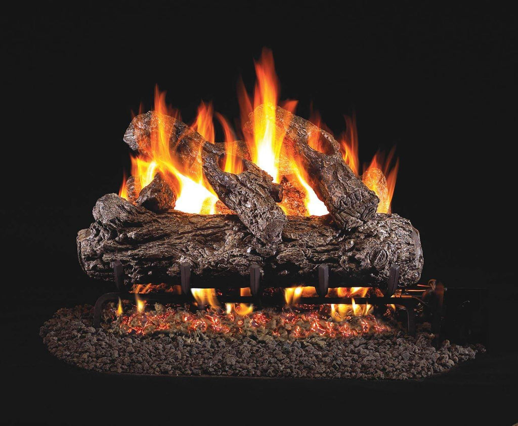 Vented gas log set with glowing flames in rustic charred log arrangement on base