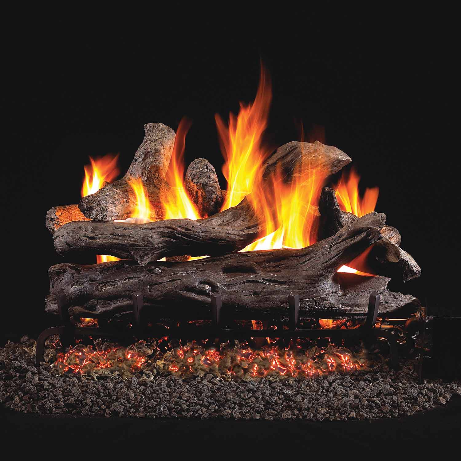 Coastal driftwood vented gas log set with glowing flames and embers over lava rock