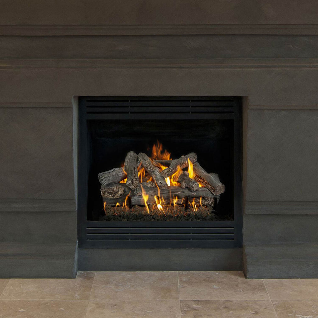 Vented gas log set inside a square fireplace opening with gray logs and orange flames