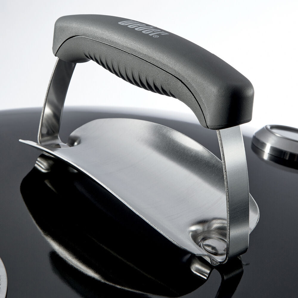 Kettle grill lid handle and latch on black lid with silver frame
