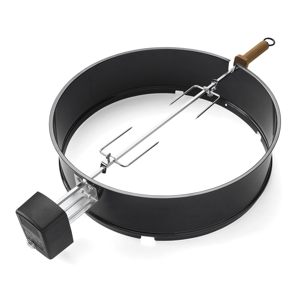 Black rotisserie kit with circular tray and metal spit with two forks