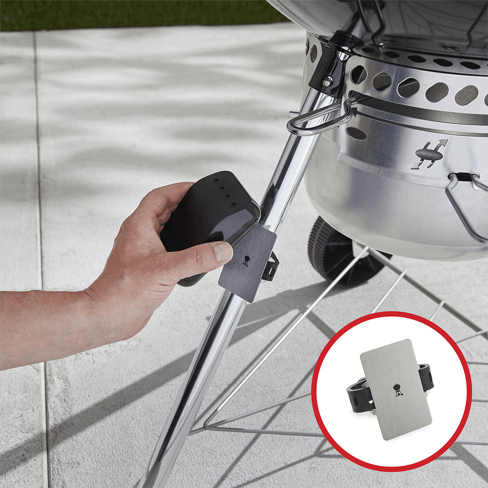 Stainless steel grill mounting bracket being aligned on legs