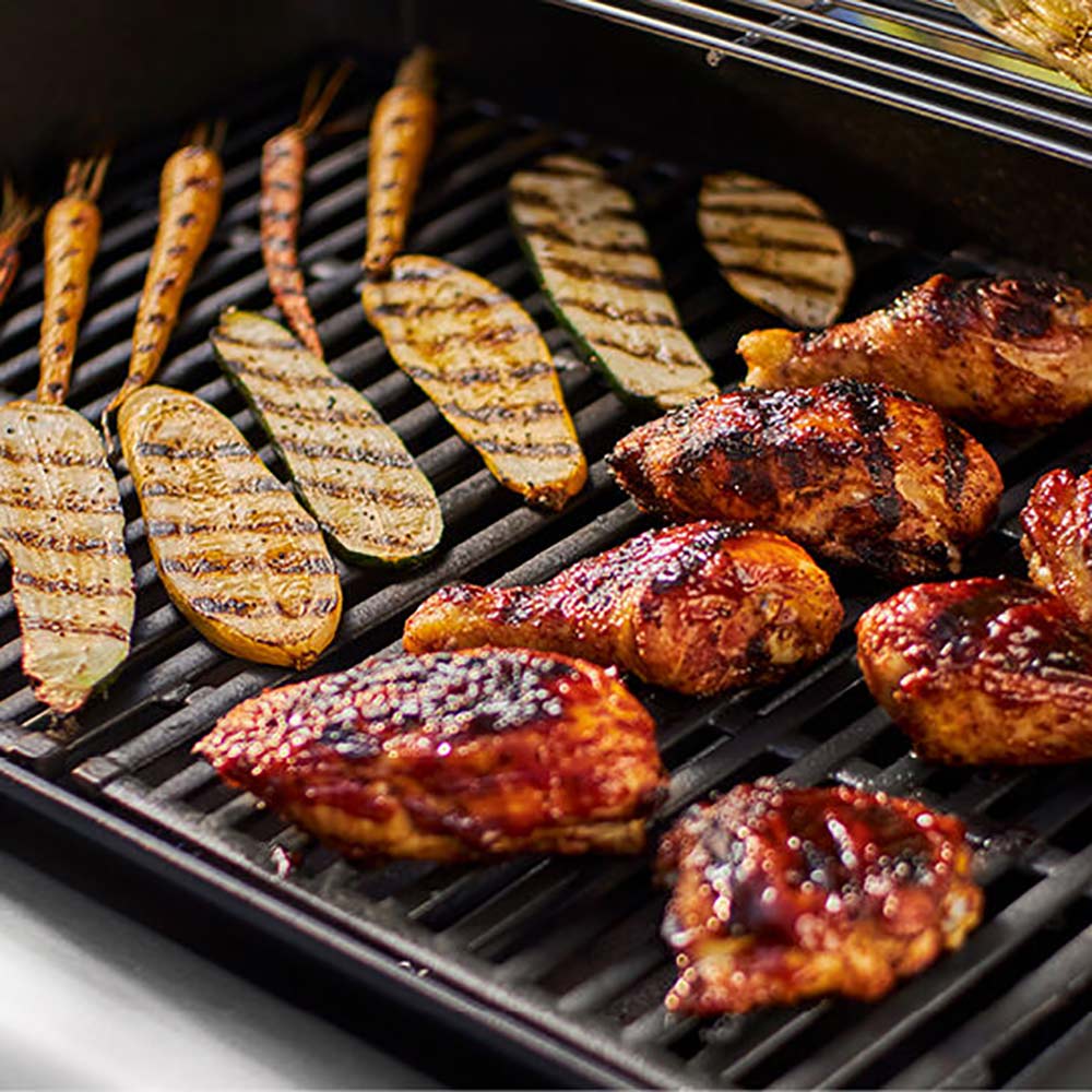 Grilled chicken and vegetables on a barbecue grill