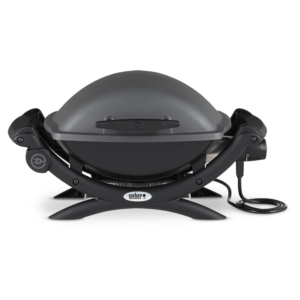 Electric grill with closed lid, black body, side handles, power cord