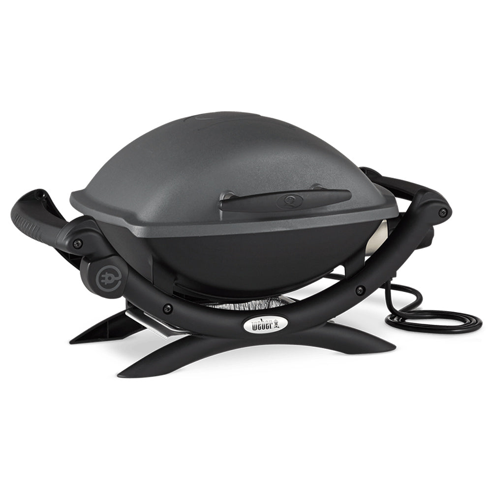 Electric grill with closed lid, black cooking unit on three legs, power cord