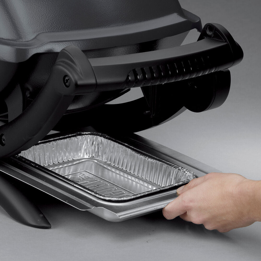 Electric grill drip tray with foil liner, hand lifting the inner tray