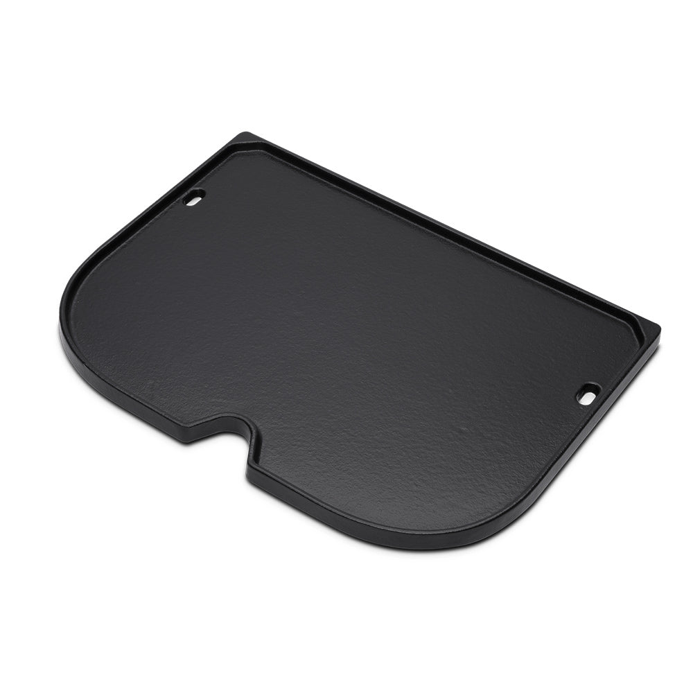 Black griddle plate with side notch and two mounting holes, angled view of base