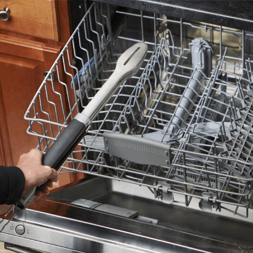 Stainless steel grill tongs in a dishwasher rack