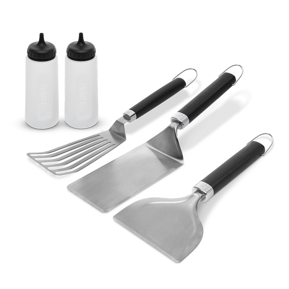Griddle tool set with two spatulas and slotted scraper, plus two white seasoning bottles