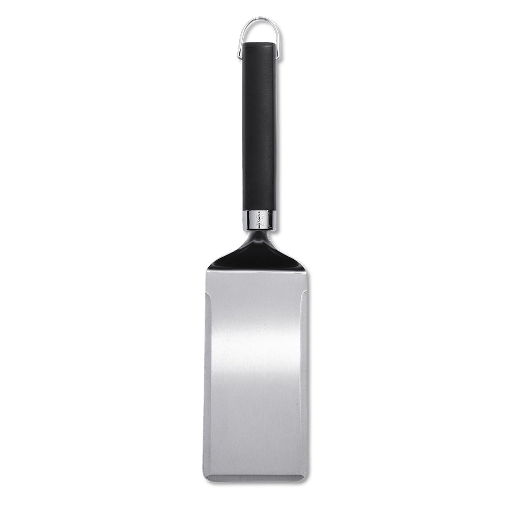 Griddle spatula with wide stainless steel head and black handle, hanging loop
