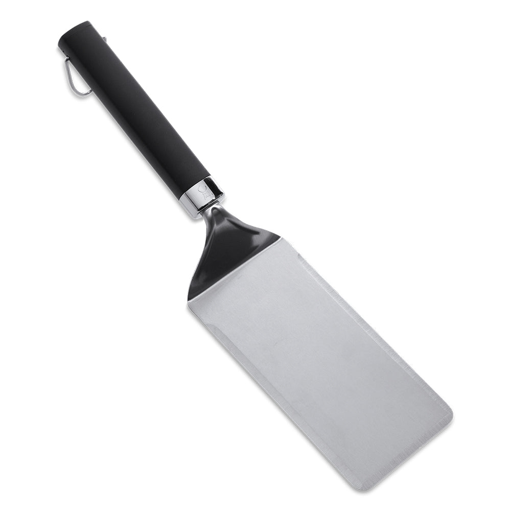 Griddle spatula with wide stainless steel blade and black handle, angled