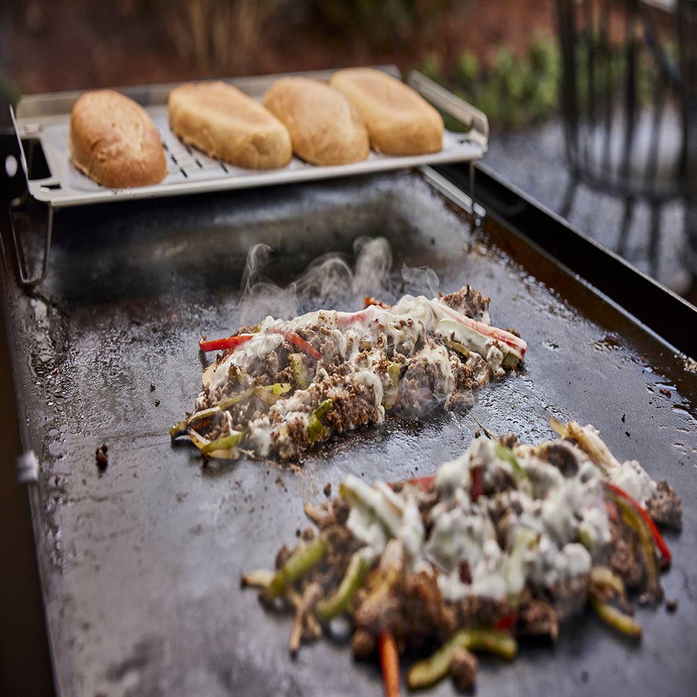 Weber griddle keep warm rack holding sliced meat, mesh top with supports