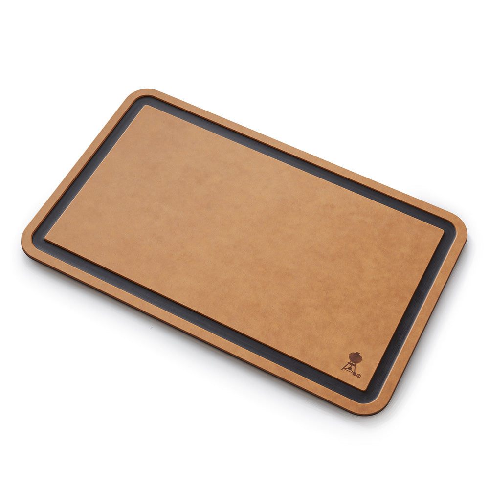 Cutting board with tan surface and dark charcoal border, rounded wooden-look edge.