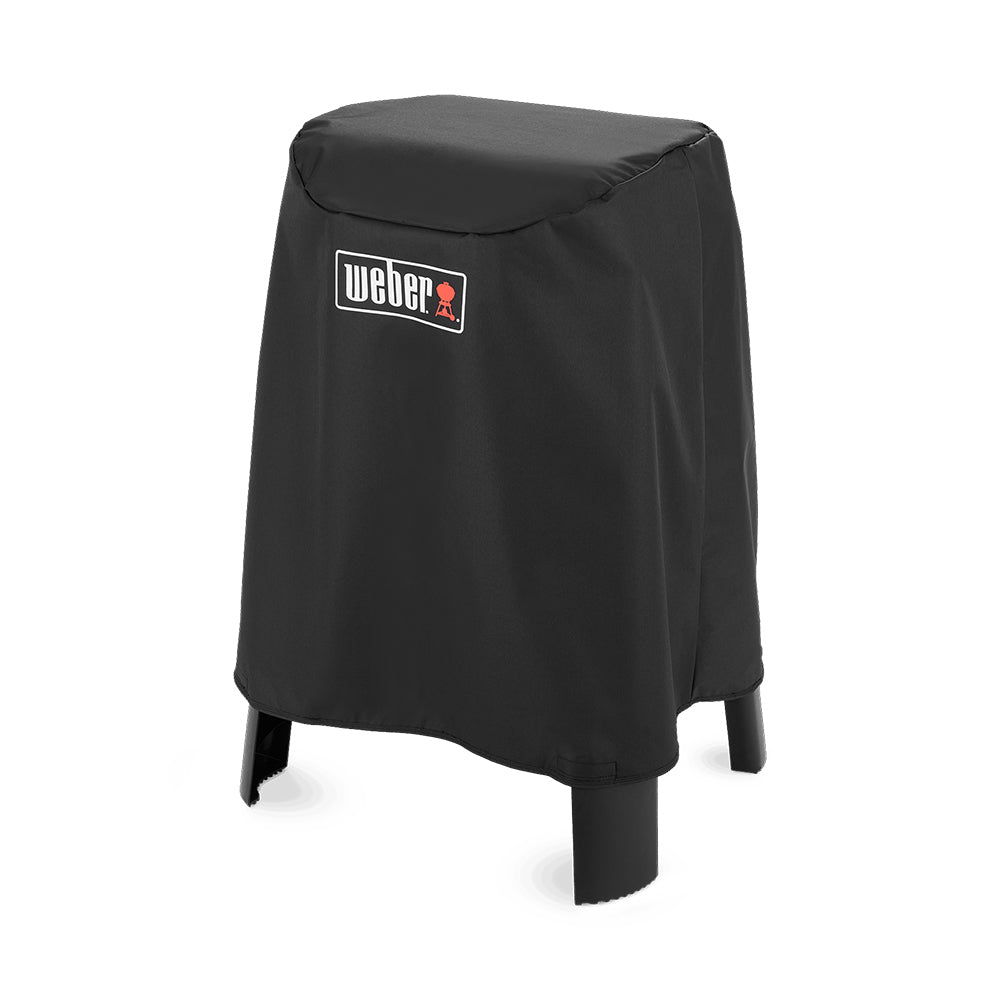 Black Weber grill cover, fitted domed top over a grill on stand legs