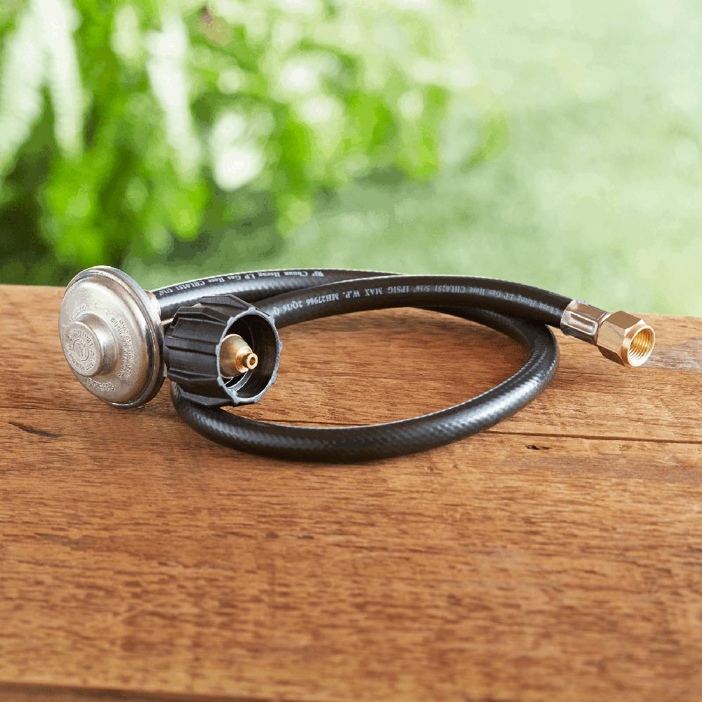 Gas grill hose and regulator kit with black hose, regulator housing, and brass connectors.
