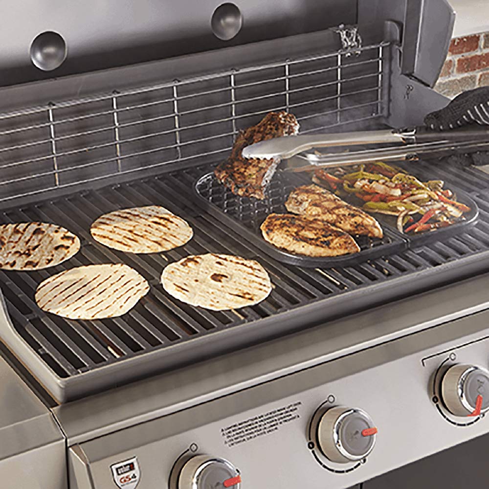 Griddle insert on grill cooking tortillas, meat, and vegetables on the flat surface
