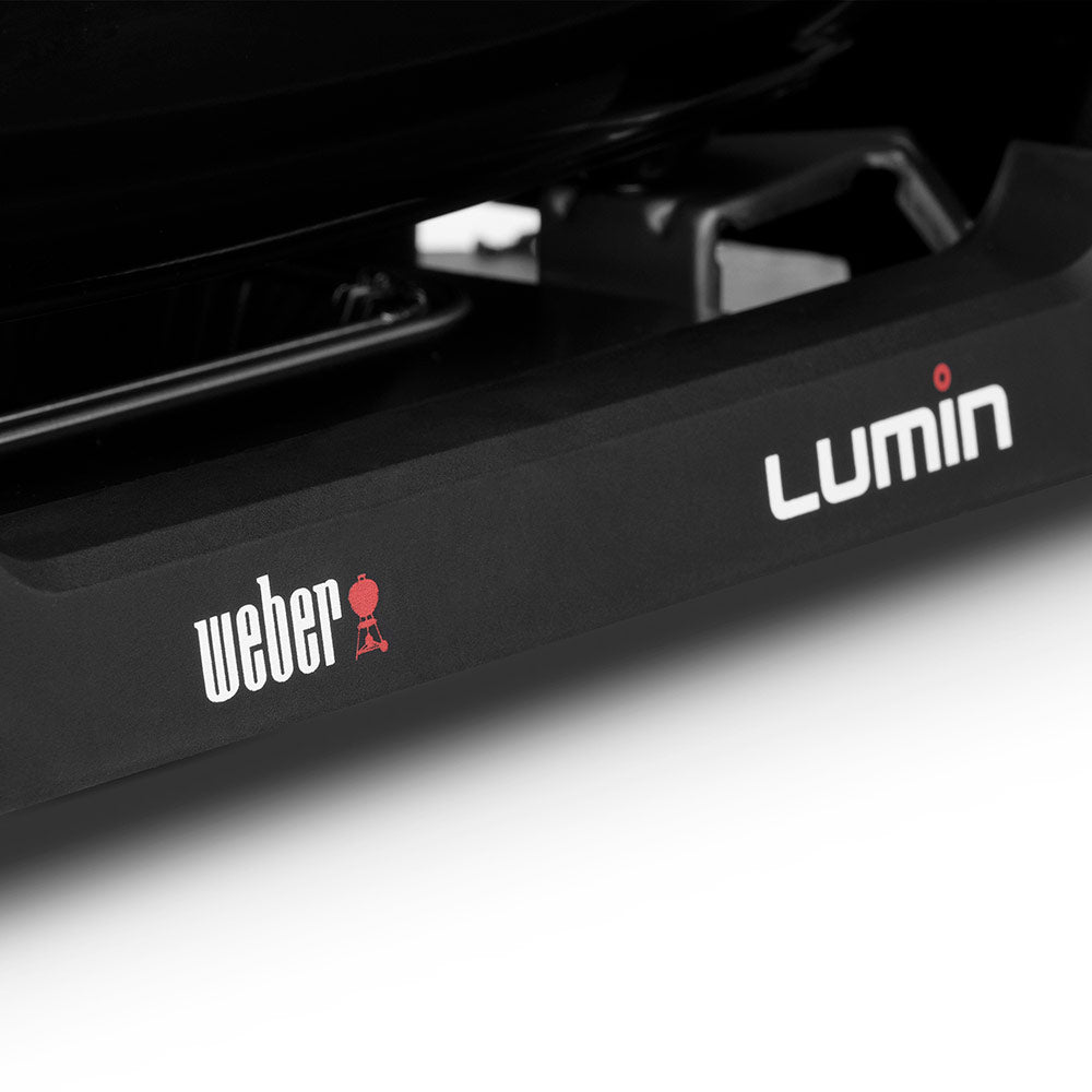 Black grill front panel with Weber logo and “Lumin” label.