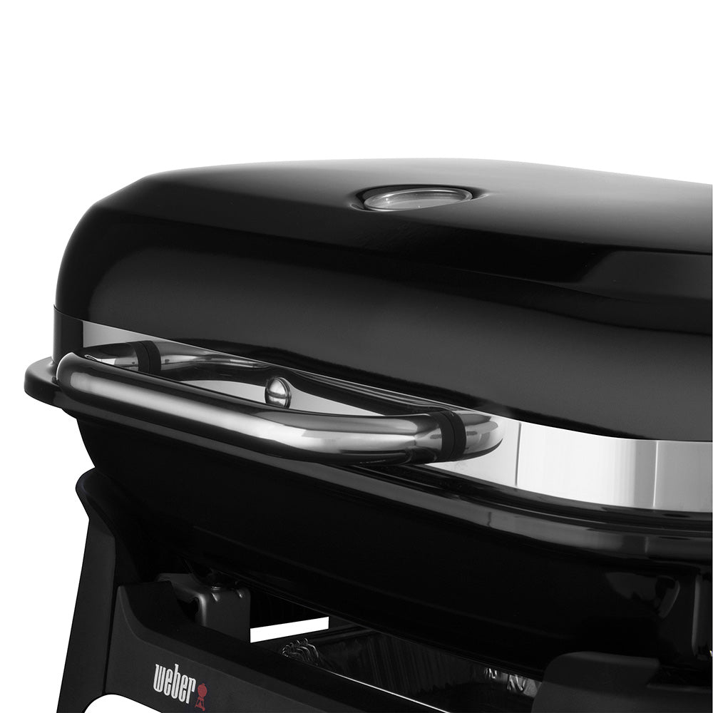 Black grill lid with handle and metal trim, front Weber logo visible.