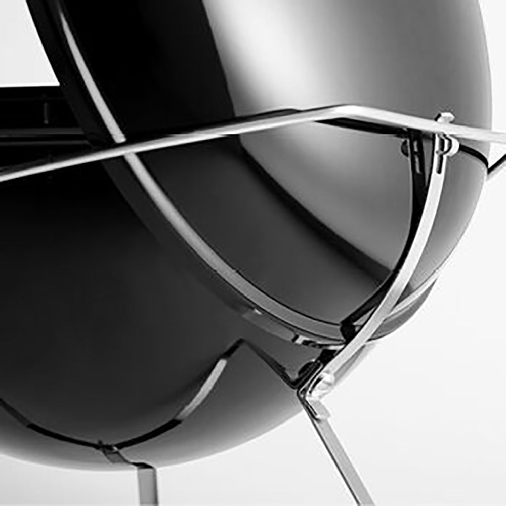 Close-up of charcoal grill lid support and side handle frame, glossy black.