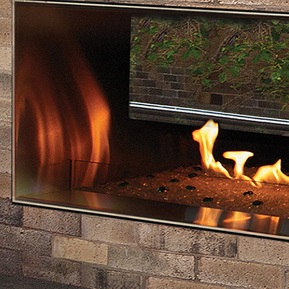 Outdoor linear fireplace glass wind guard with dark frame around open flame