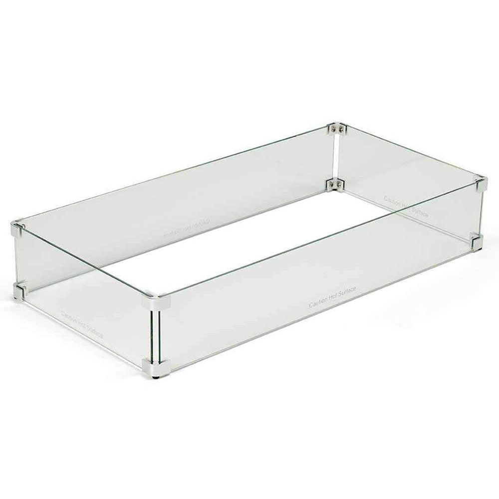 Linear fire pit wind guard with clear glass panels and metal corner supports