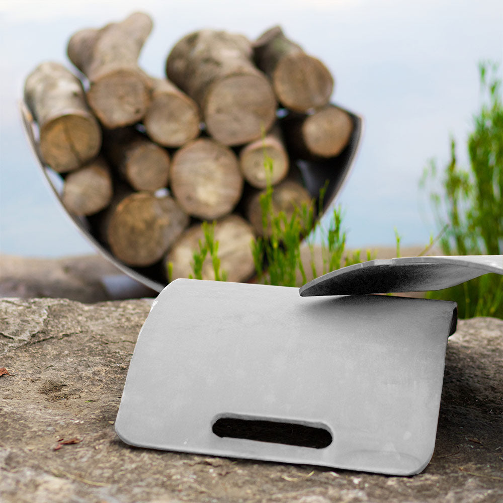 Stainless steel log rack holding stacked firewood with wing-shaped curved base