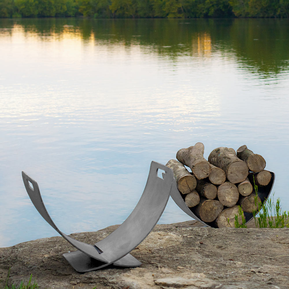 Stainless steel log rack with curved wings holding stacked firewood