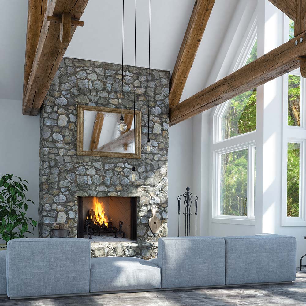 Indoor fireplace with stone surround and burning fire in a dark firebox
