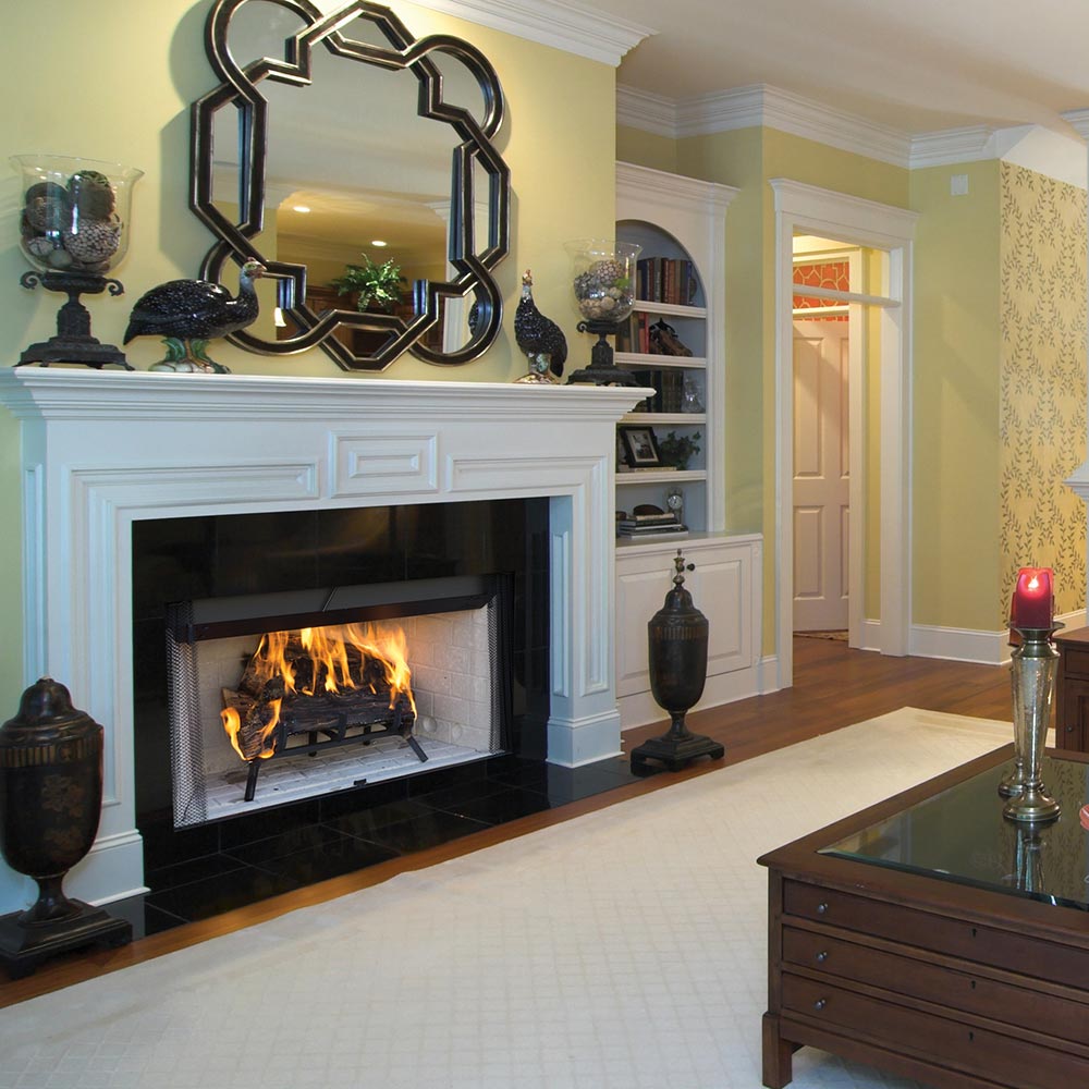 Wood-burning fireplace with firebox and decorative metal trim on mantel