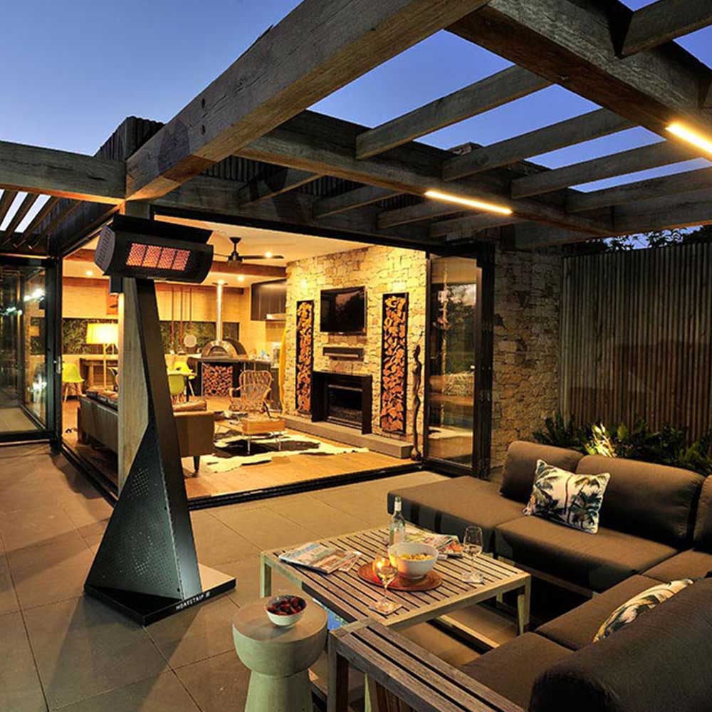 Freestanding LPG gas patio heater with glowing heat panel in a black hood