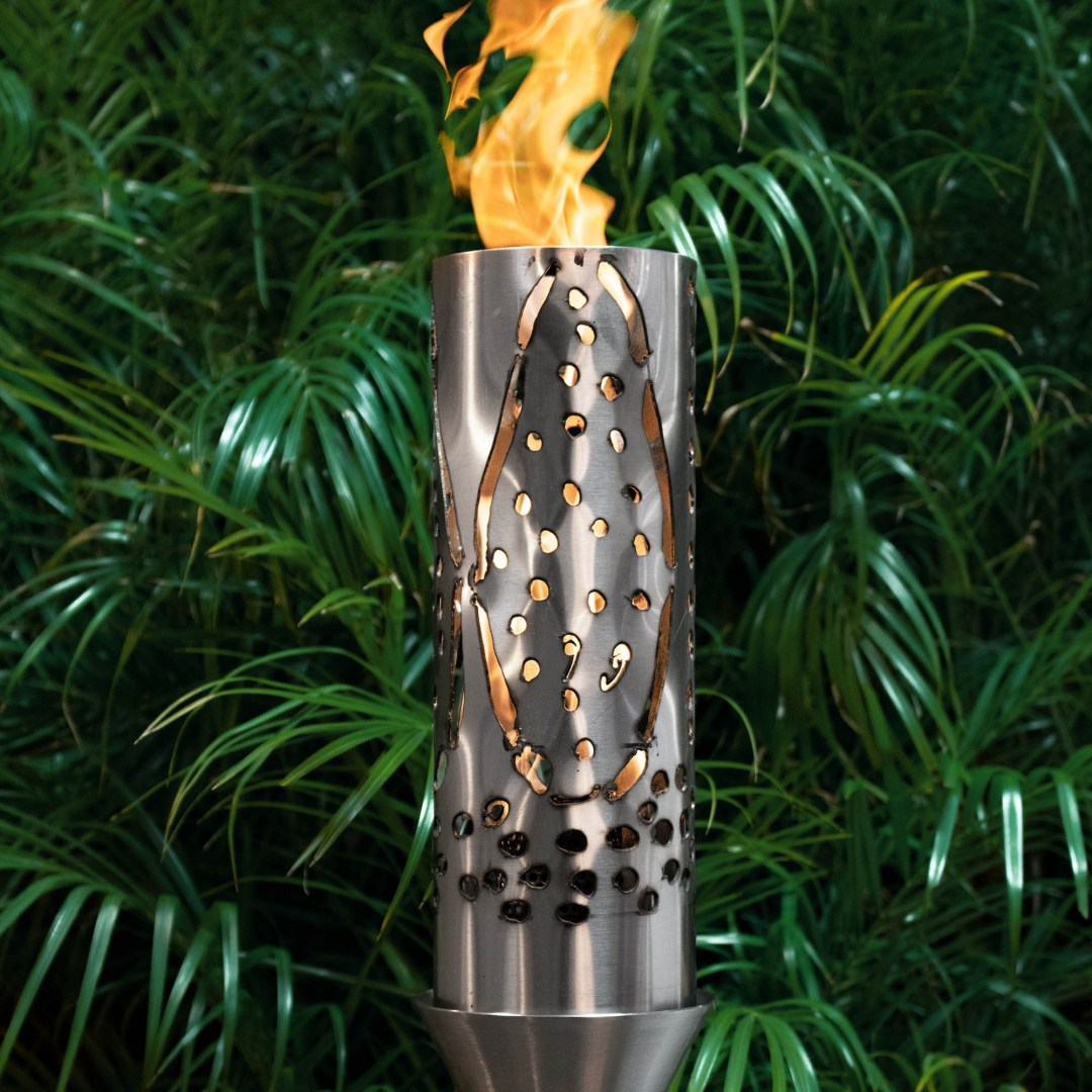 Outdoor metal flame torch with perforated cylinder and rising flames, on stand