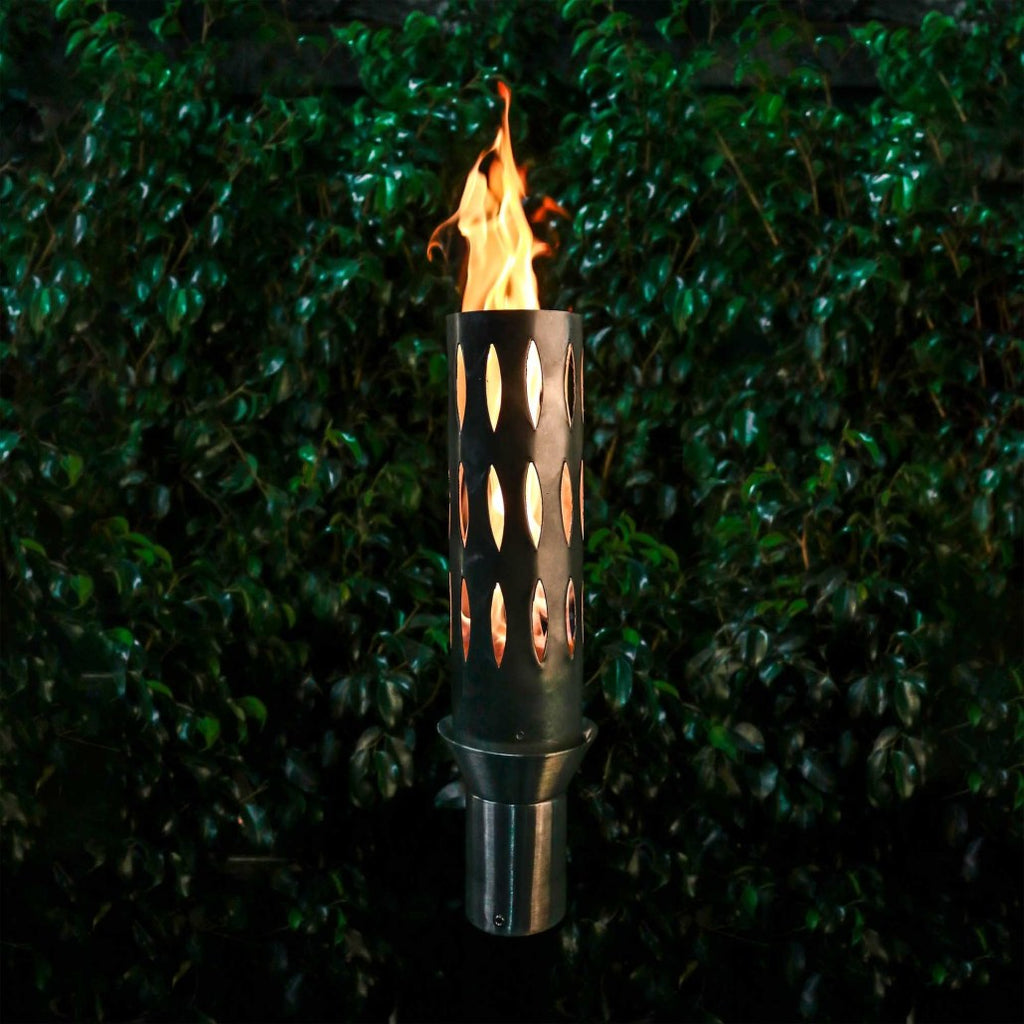 Outdoor torch with perforated cylinder stand, burning flame in dark metal housing