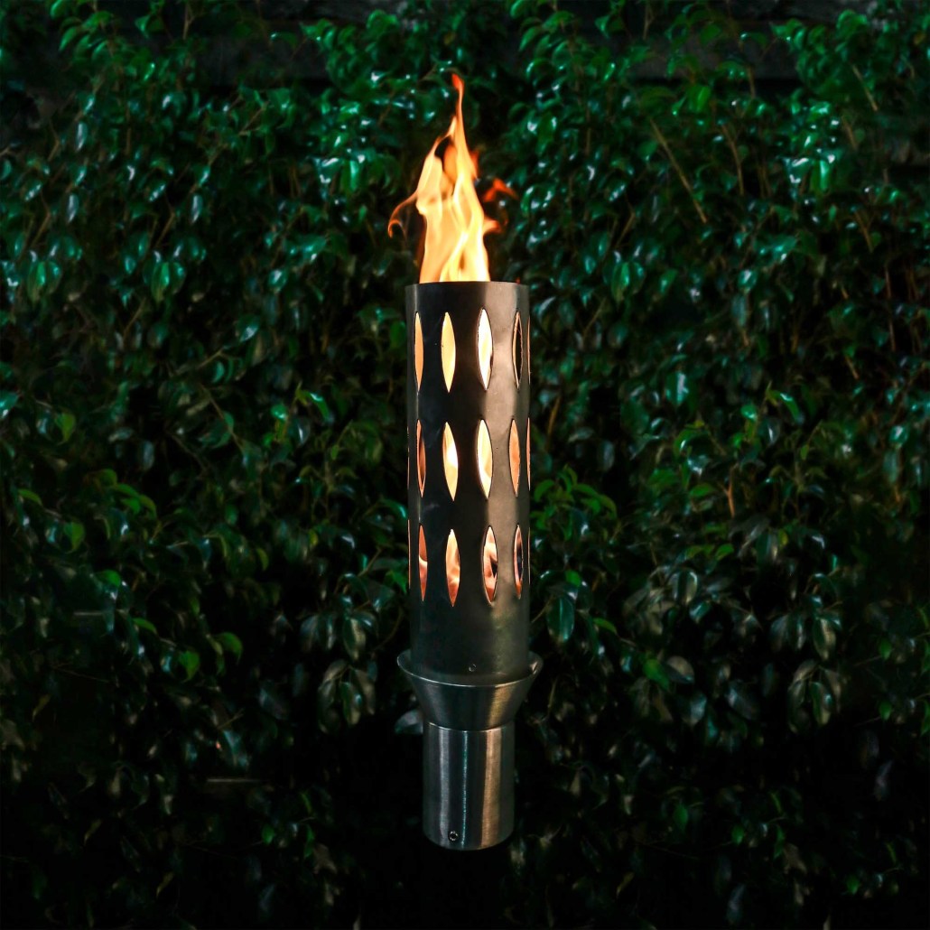 Outdoor torch with perforated cylinder stand, burning flame in dark metal housing