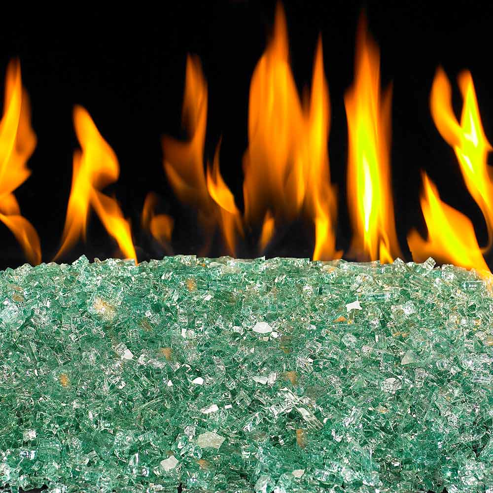 Emerald green fire glass pebbles with flames burning behind