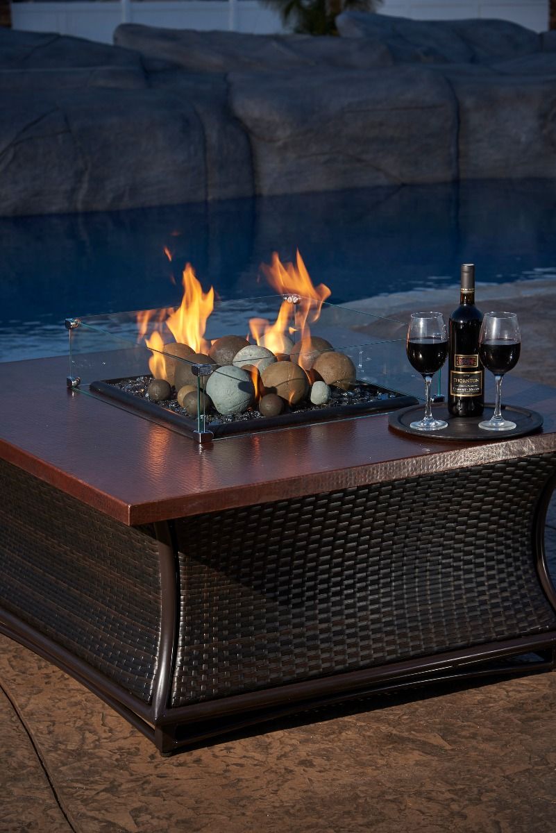 Outdoor fire pit table with flames and lava rocks