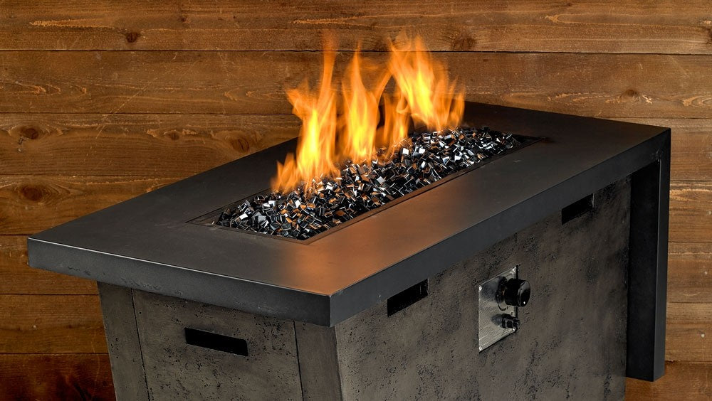 Black fire pit with flames over fire glass