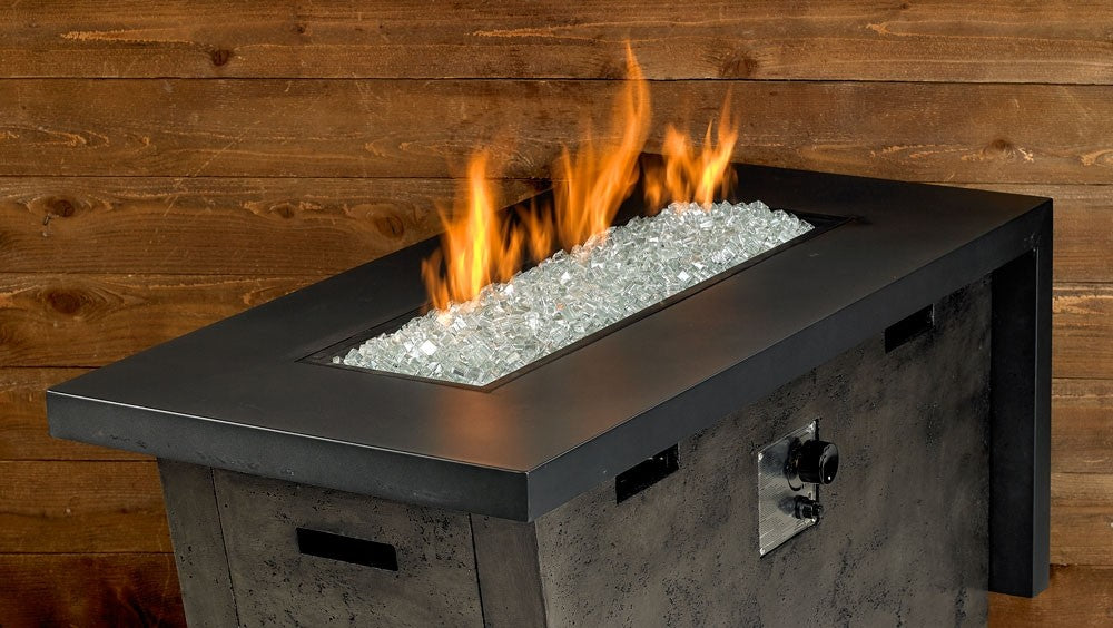 Rectangular fire pit with clear silver fire glass cubes and flames above