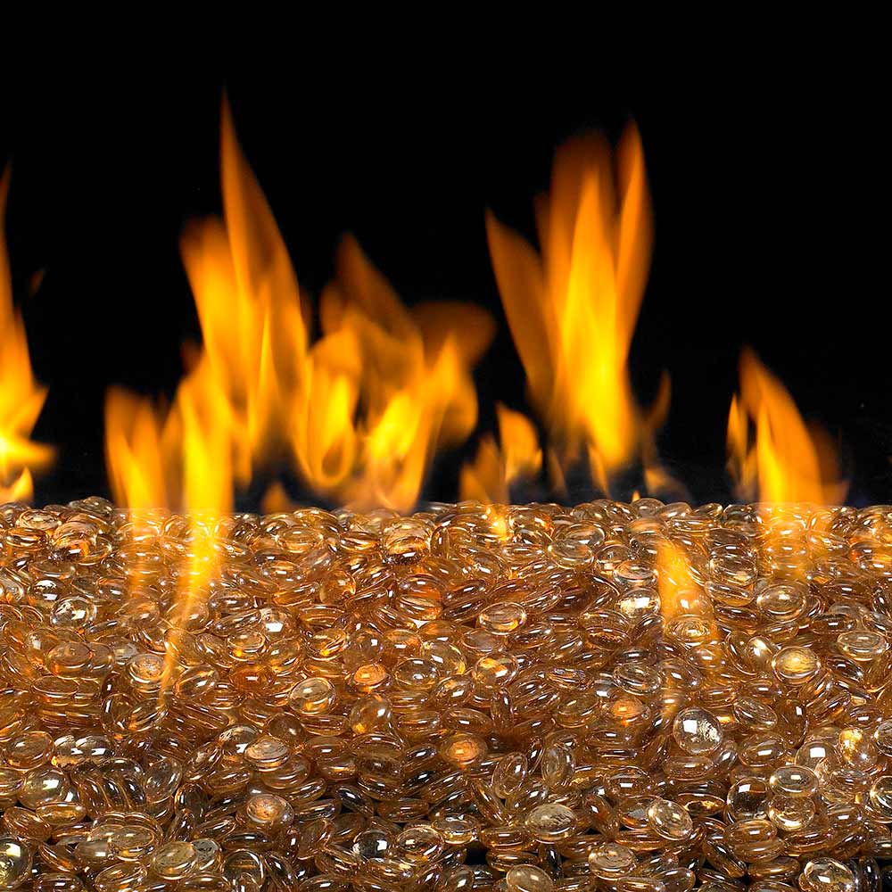 Fire pit bed of champagne fire glass gems with golden amber glowing stones