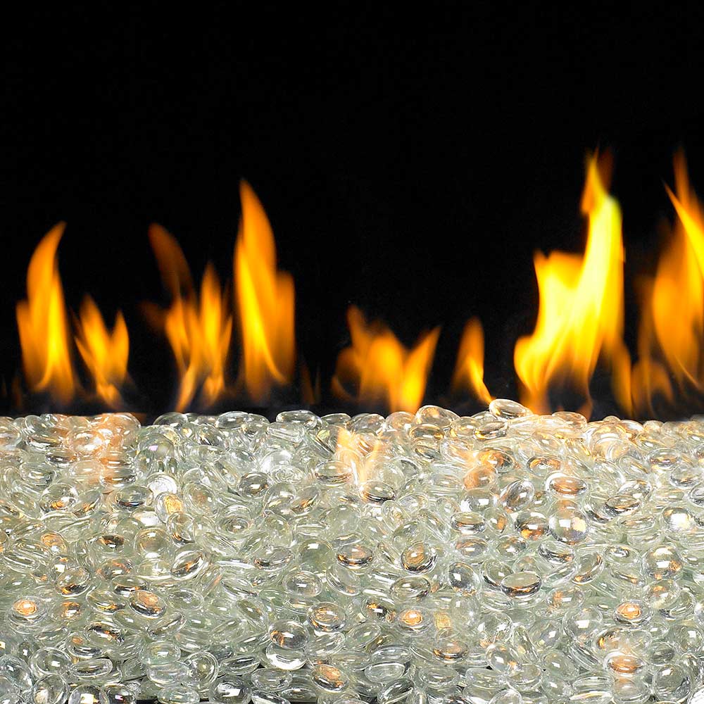 Glacier Fyre gems, translucent glass pebbles in front of fire