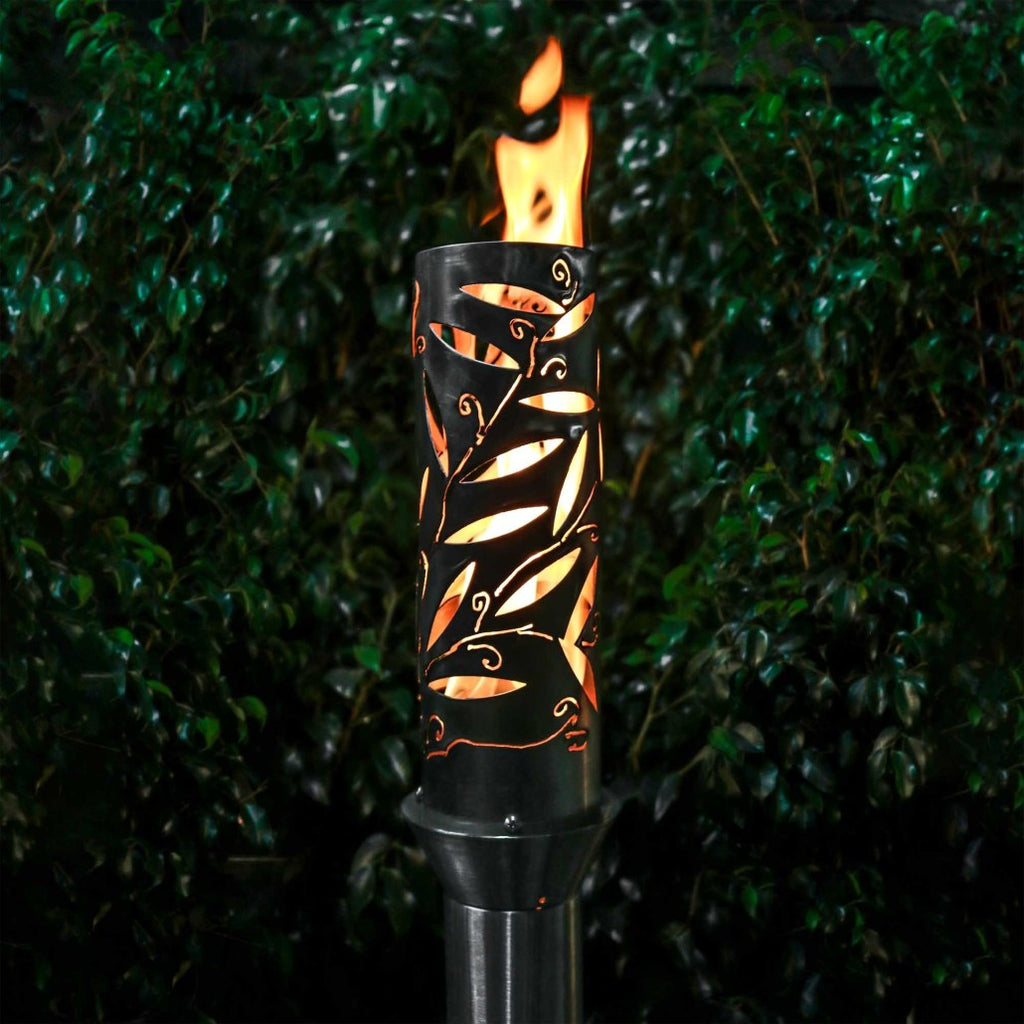 Orange-and-black metal outdoor torch with flame in open top