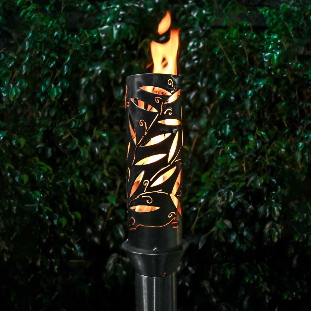 Orange-and-black metal outdoor torch with flame in open top