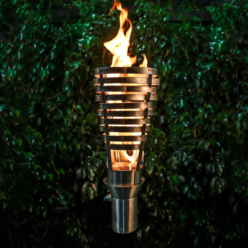 Outdoor torch with flame, metal cylinder guard and stand