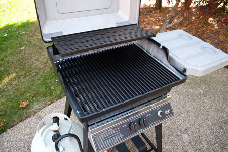 22-inch gas grill with lid open, ribbed grates, and front control knobs