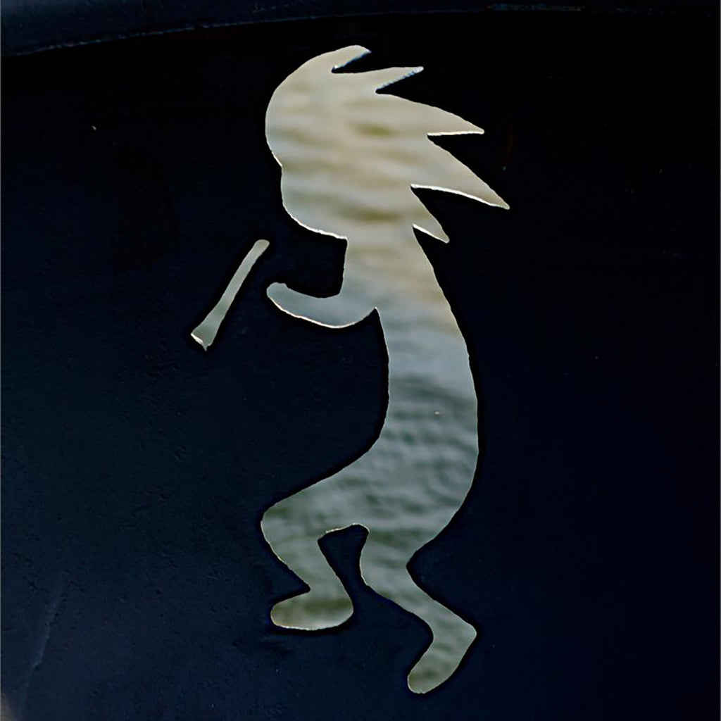 Close-up of Kokopelli metal cutout on dark fire pit bowl